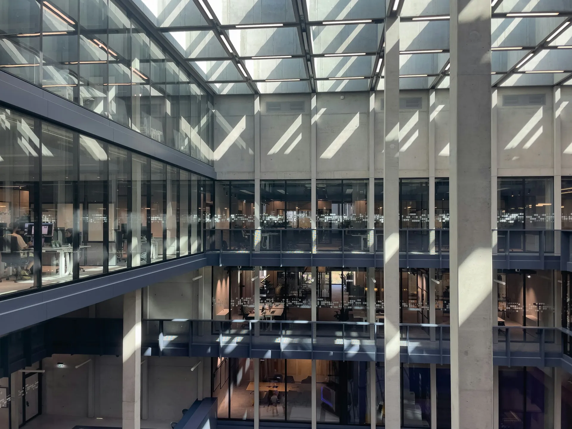 Multi-storey commercial building atrium with glass walls and skylights
